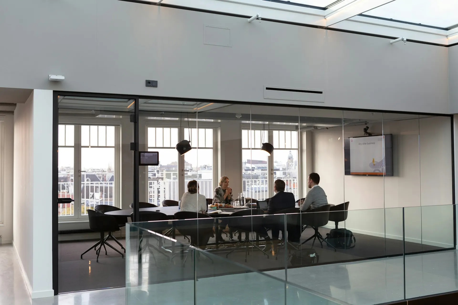 Business laptops in use during a workplace meeting, representing laptop hardware supply categories.
