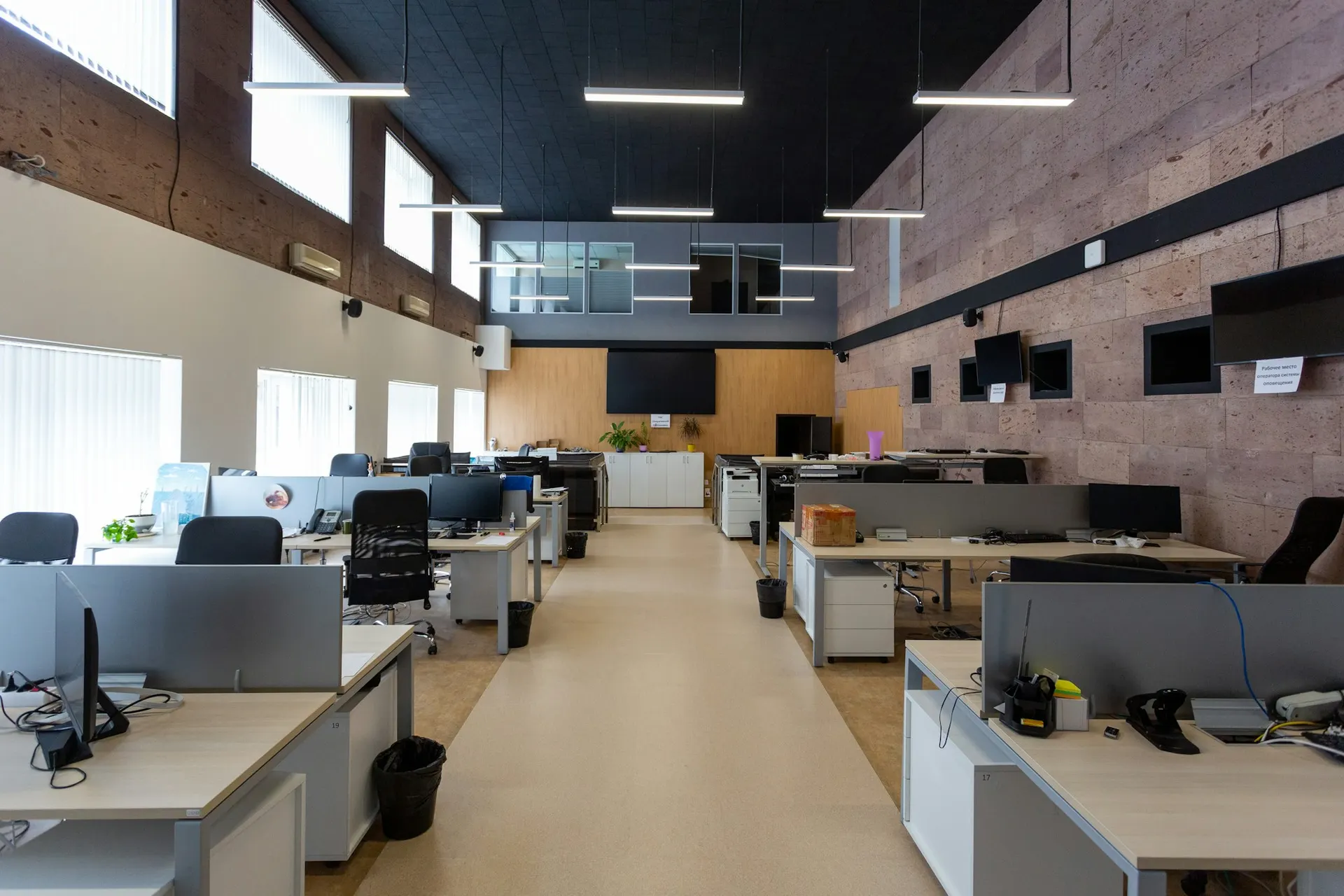 Open-plan office workstations equipped with business technology.