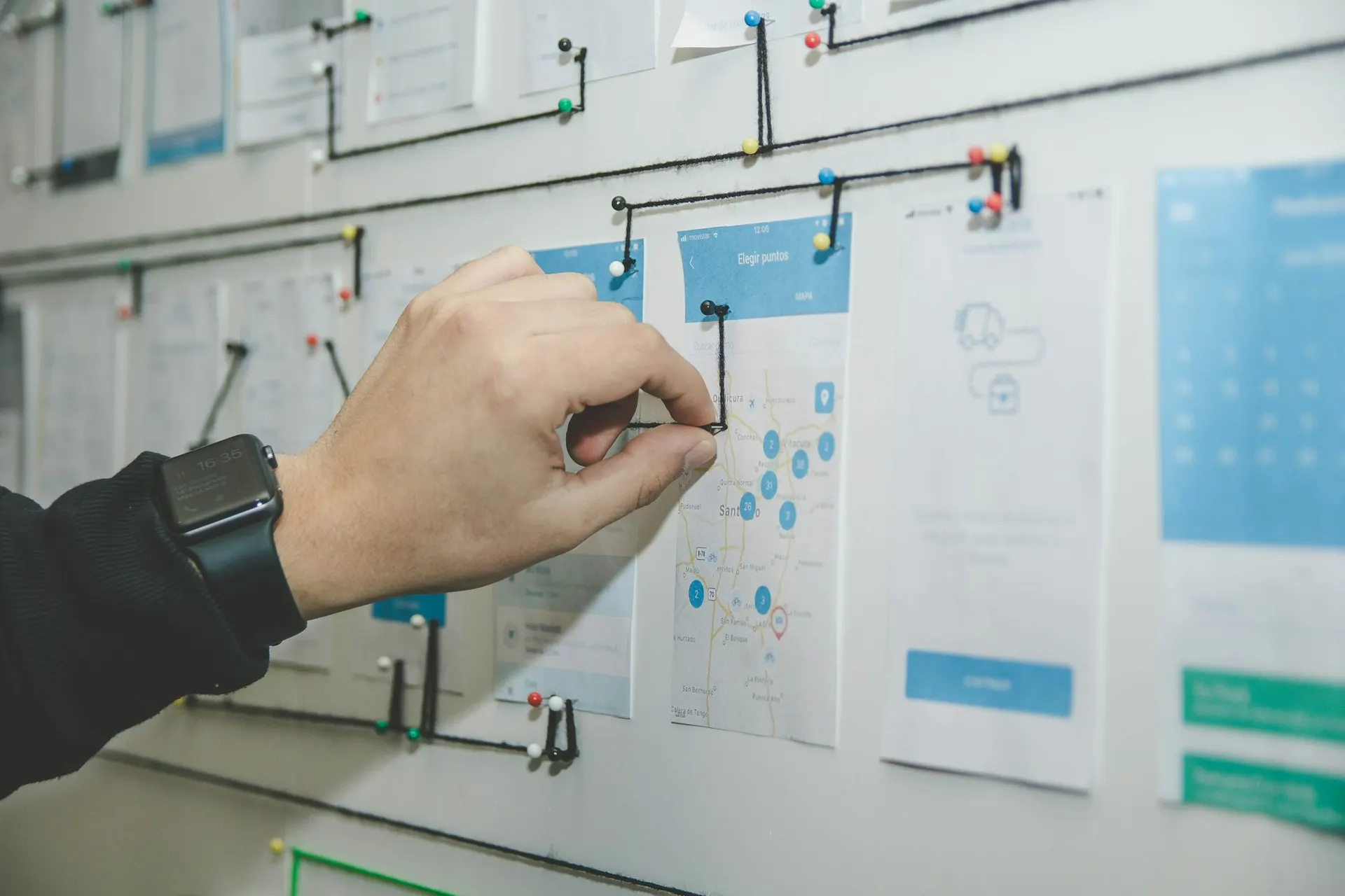 A business team mapping out a technology procurement process on a whiteboard.
